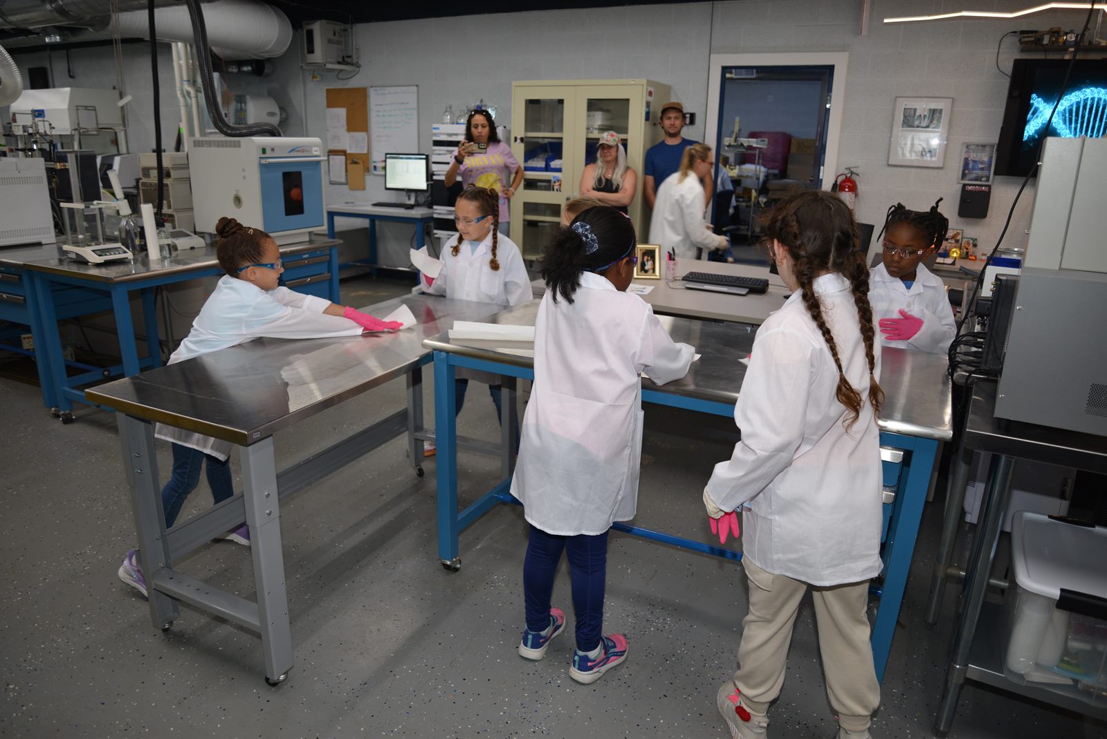 MiLab students touring the lab in their lab coats